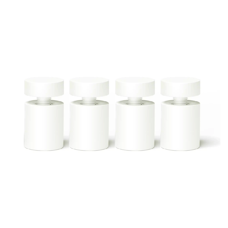 four white standoffs used for installing signage onto a solid wall